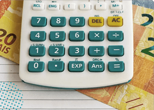 Image of a calculator with 20 bills in the background